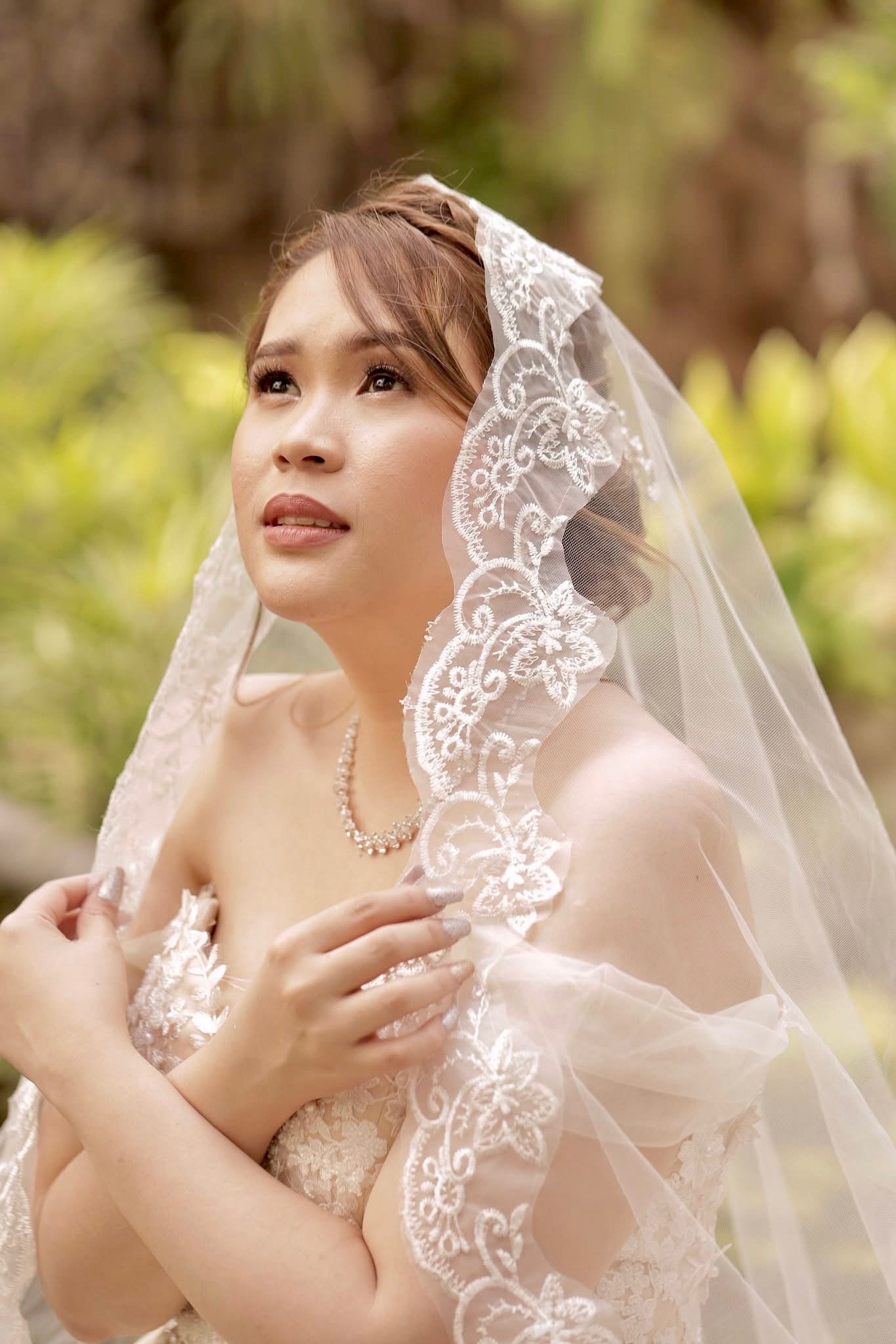 Bride during her makeup trial, seated calmly as her look is refined.
